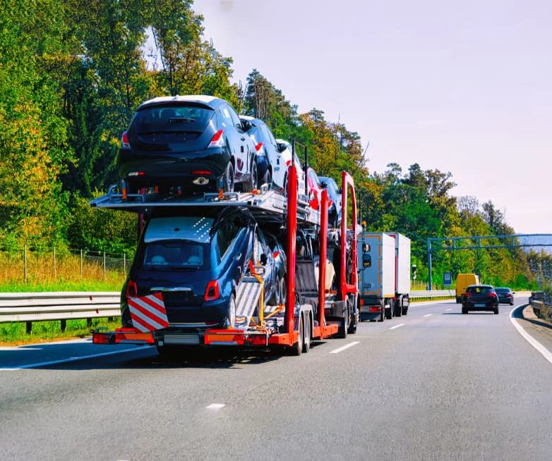 Vehicle being delivered door to door by an auto transport carrier