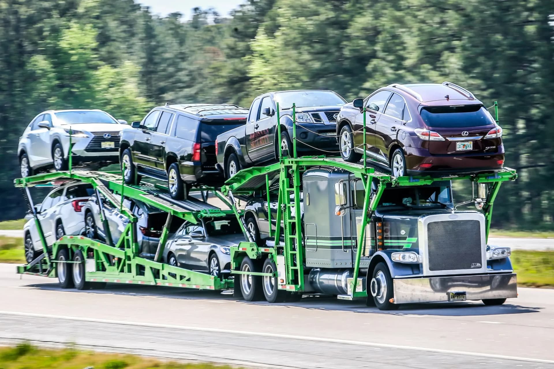 Loaded car hauler travelling a rural highway